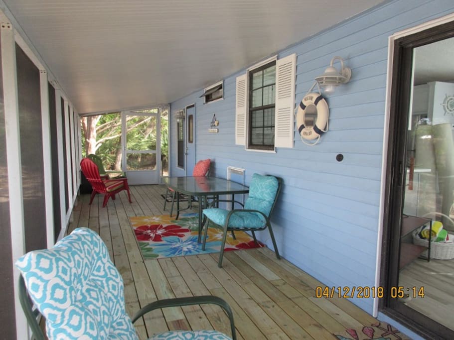 Enter the large screen porch where you can enjoy morning coffee, a meal or an evening cocktail.