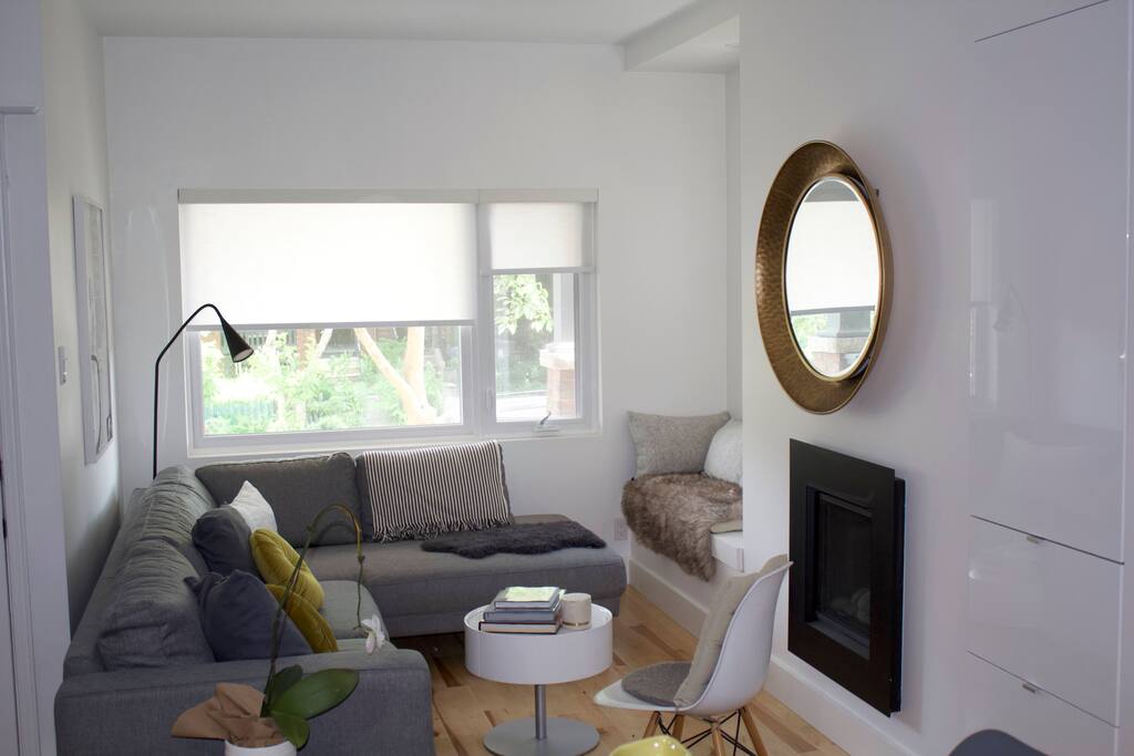 Bright living room with fire and book nest.