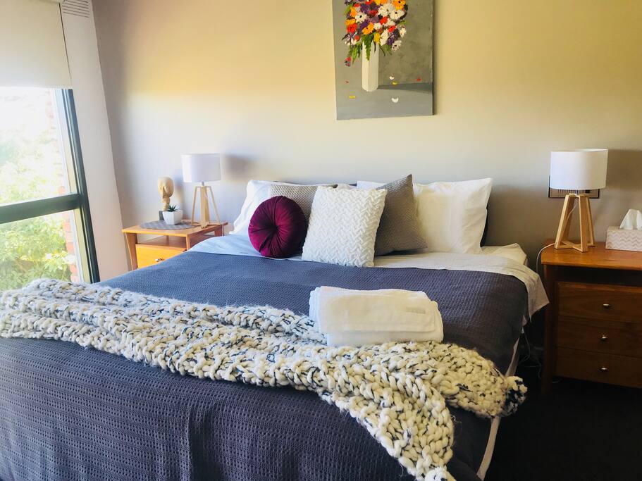 The Master Bedroom has an antique dresser, a comfy tub chair, a beautiful view, an ensuite with double showers and a huge walk-in dressing room.