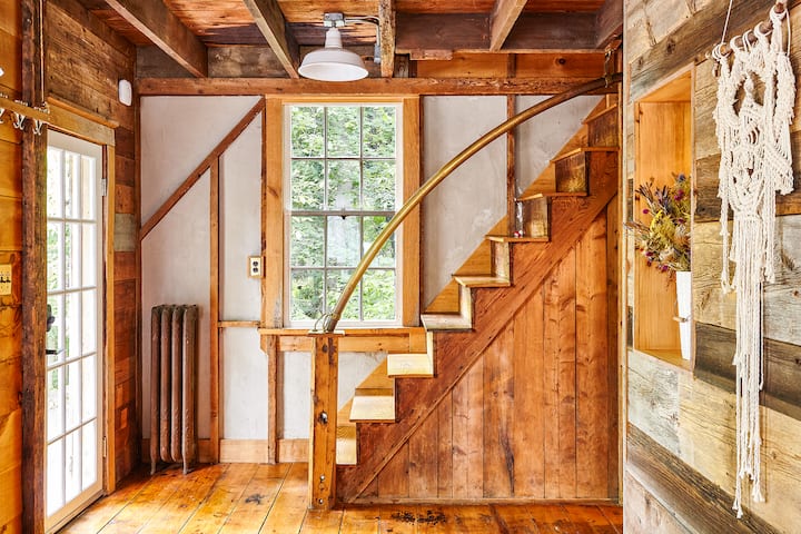 Entryway & staircase to the second floor. We love our brass pipe railing and all the different wood we have sneaked in the Barn.