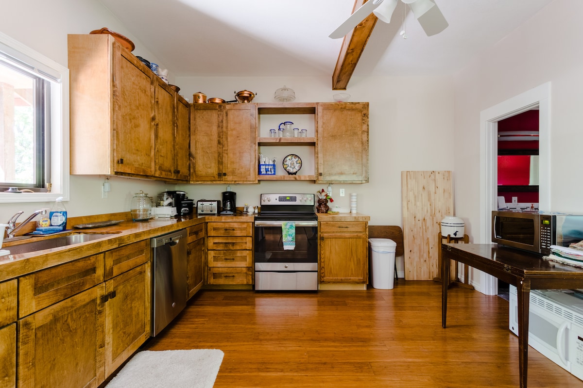 Secluded tree house apartment with high ceilings.