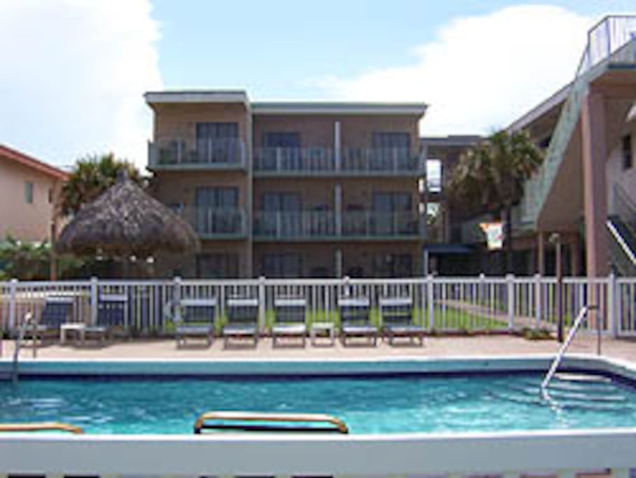 This shows the proximity of the beachfront pool. A BBQ and gazebo are between the pool and the unit.