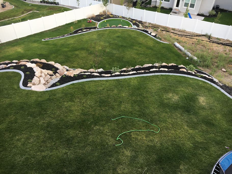 Big yard to play in with in ground tramp and putting green.