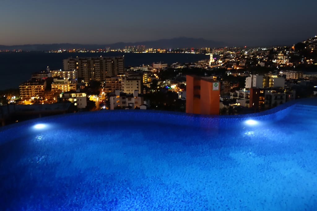 Pool and city view at night.
