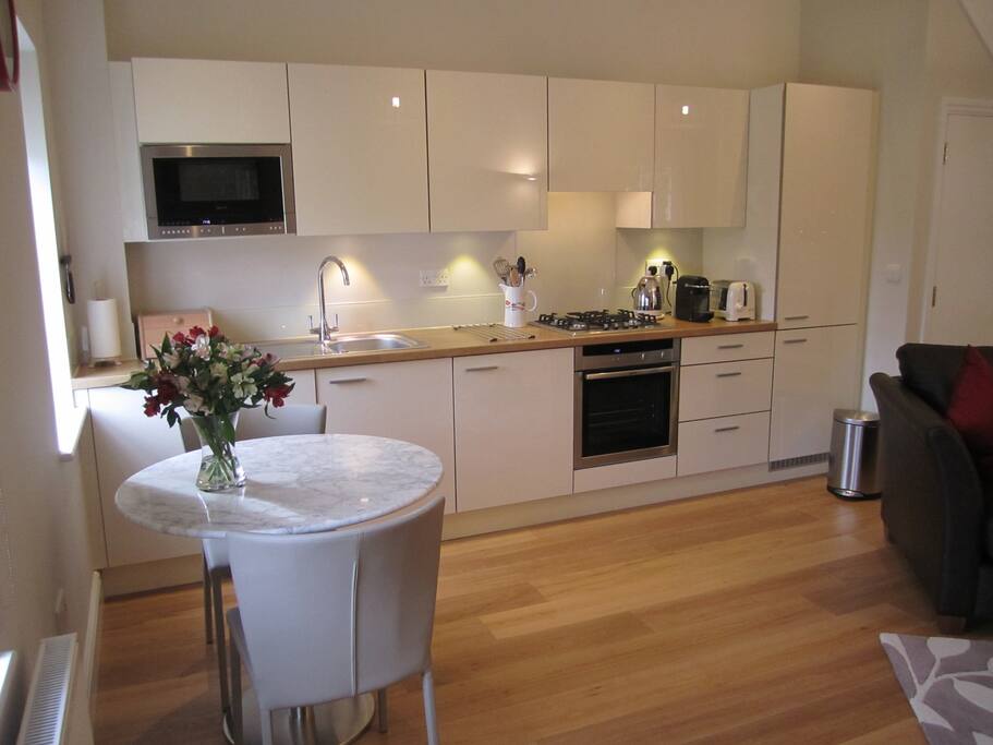 Fitted kitchen with marble dining/work table.