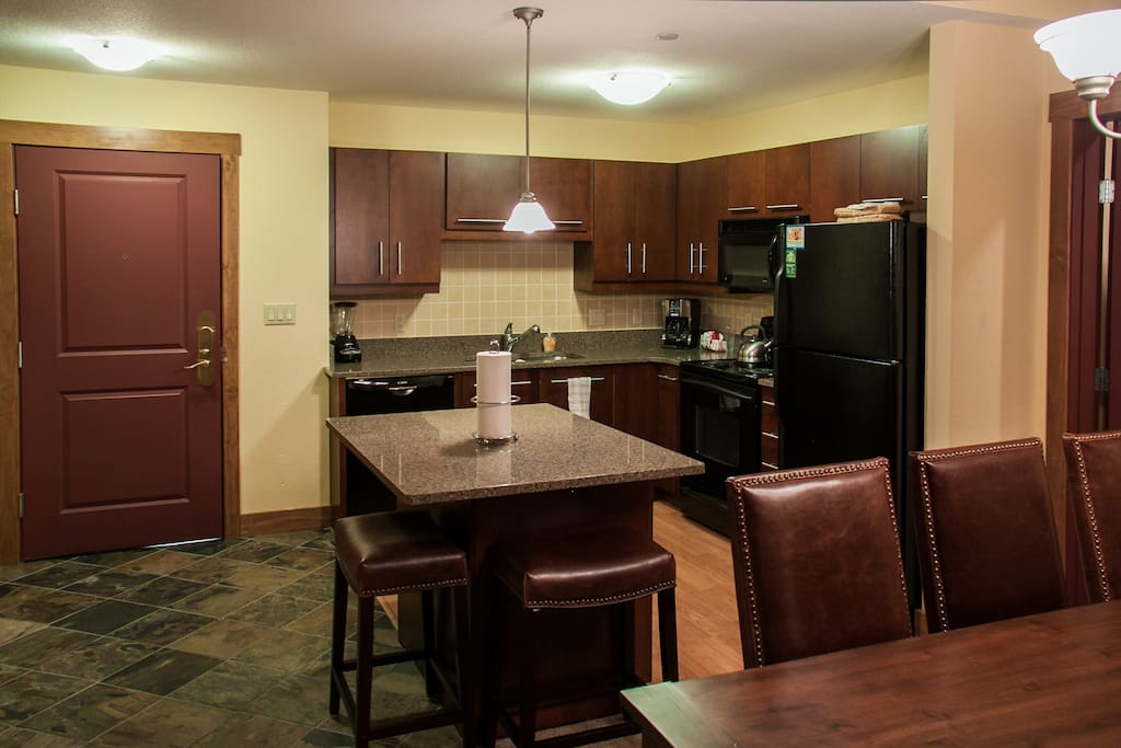 Fully stocked kitchen with island and upgraded countertops.
