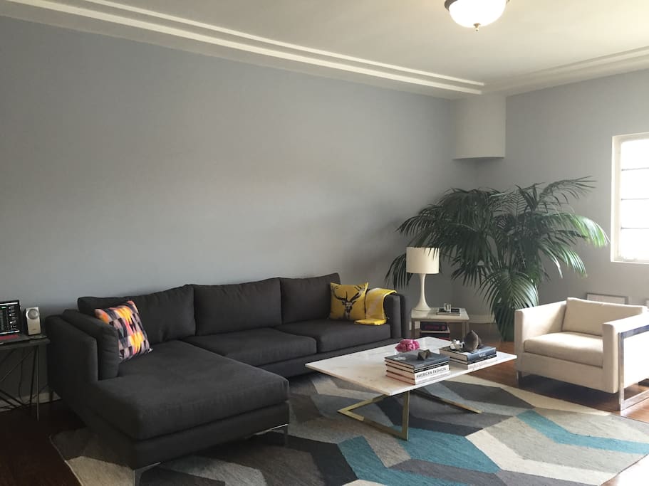 Bright, sunny large living room, cable tv, wifi, views of downtown LA with a front balcony, couch is large enough to sleep on