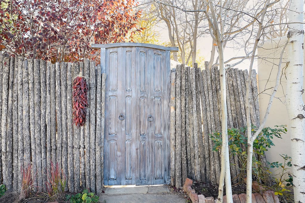 The Casita has a gated private courtyard with outdoor seating, and luscious landscape.