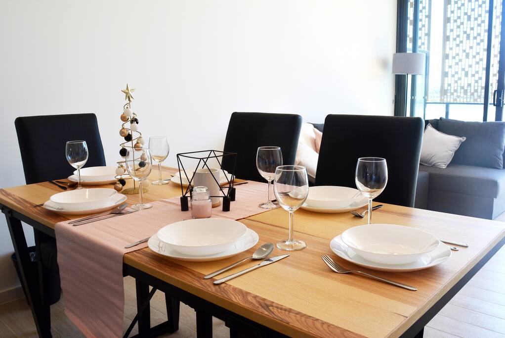 Dining Table with full sets of dinnerware provided for casual or fine dining.