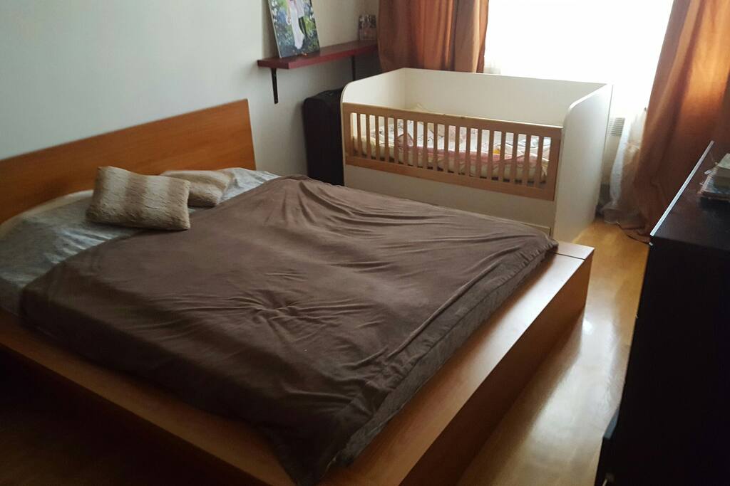 Comfortable bedroom excluding a crib.