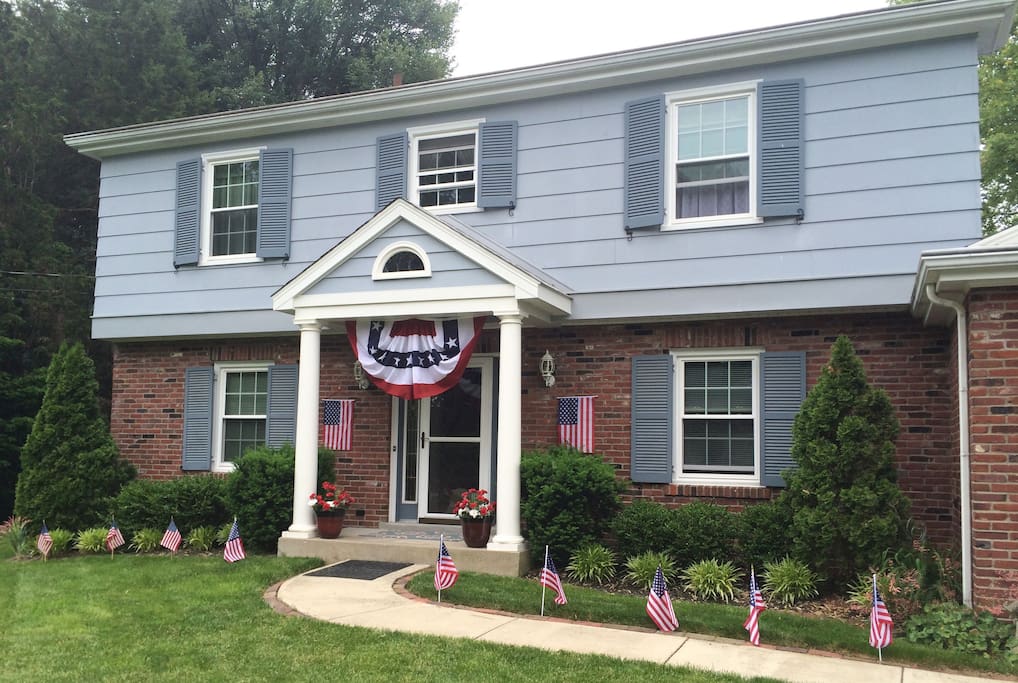 House adorned with flags for Memorial Day and 4th of July.