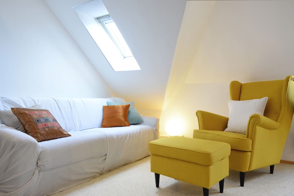 Your room with comfortable reading chair and sofa.