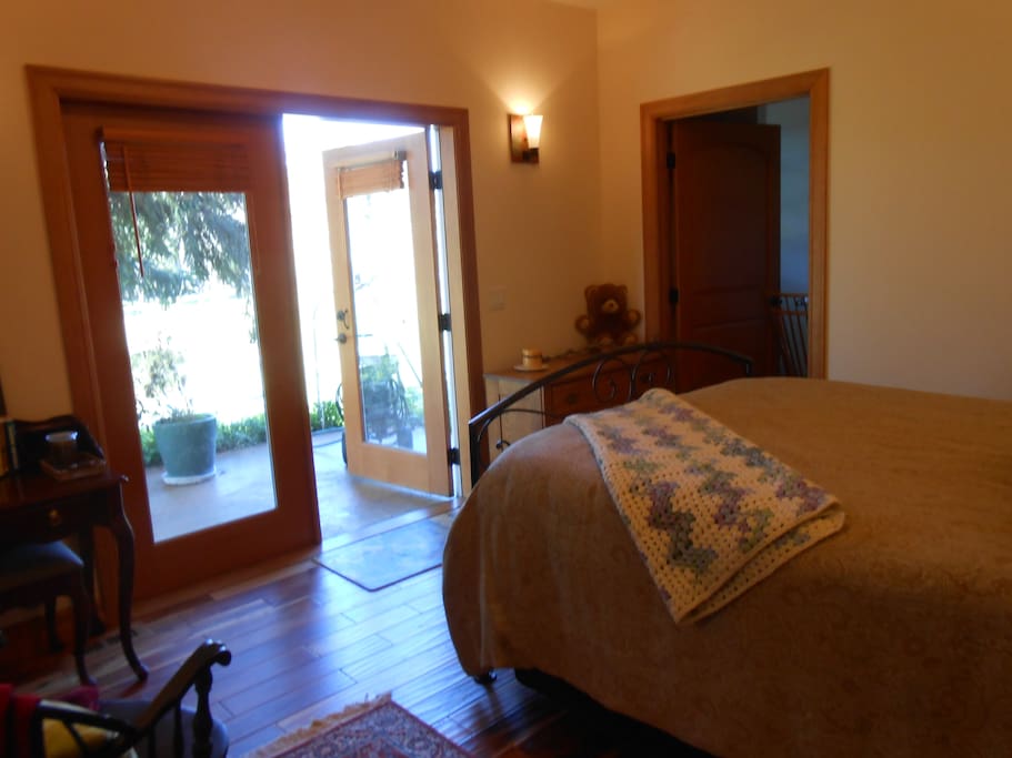 Double French doors lead out to a spacious patio overlooking the pond