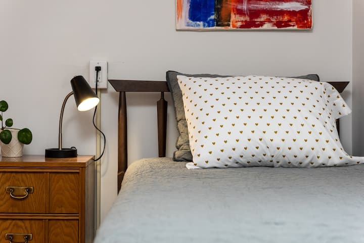 The second bedroom upstairs features vintage bedframes, dressers, and nightstands, with comfy modern mattresses & boxsprings. Art by Ohio artist and author Greg Enslen (http://www.gregenslen.com)