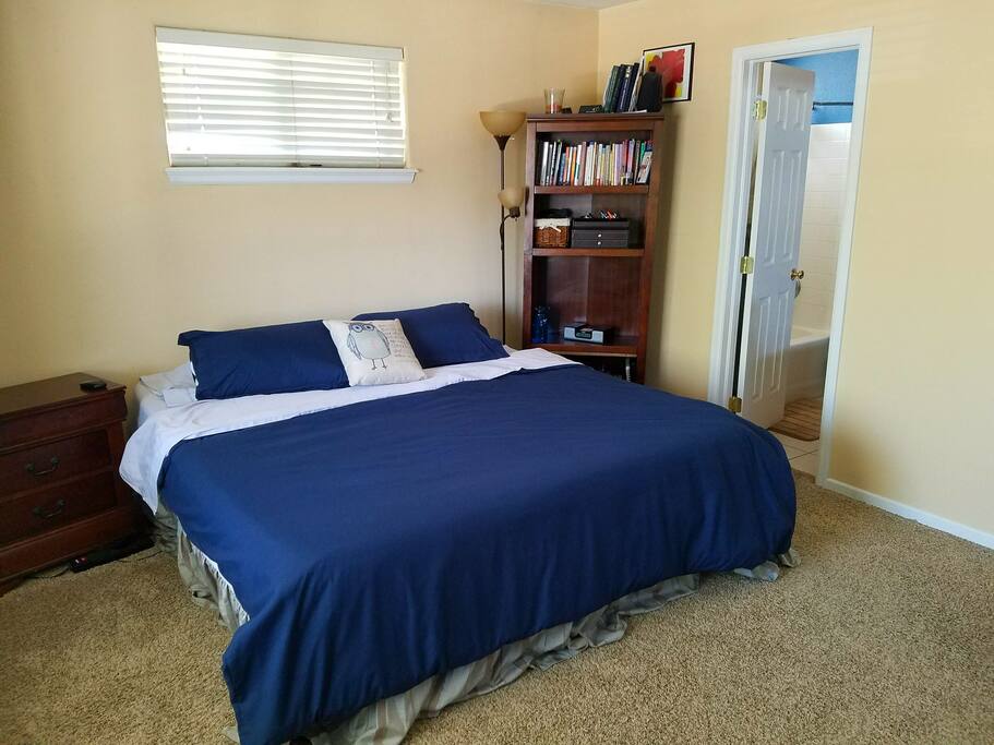 King-sized memory foam bed, along with the master bathroom doorway.