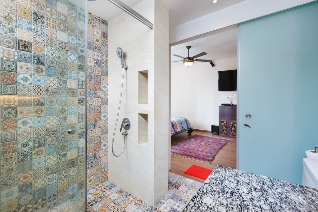 Large shower area with 20 inch rainshower. Alcove available to put your bath items. Glassdoor separates bathroom and bedroom.