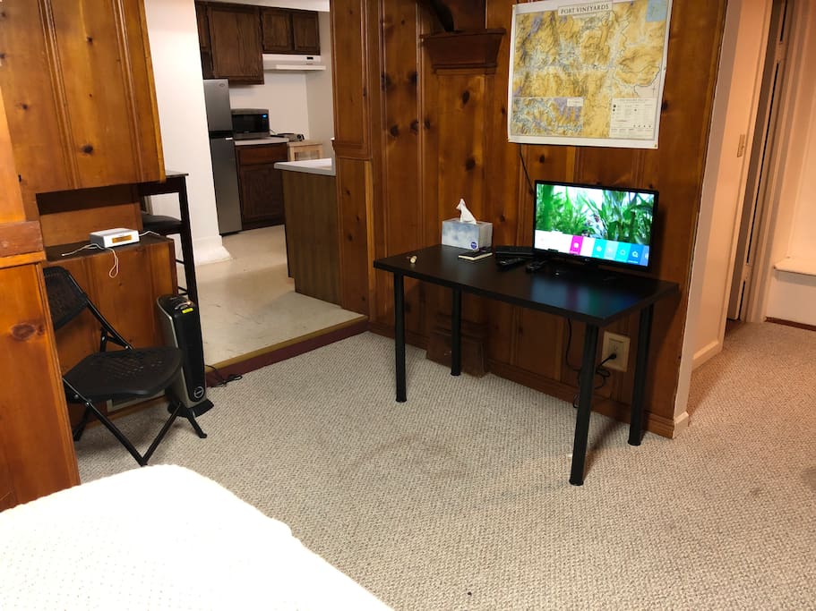Desk with a power bar so if you need to charge phones, or use your laptop you’re covered. There’s also a small smart TV, so you have Netflix, Amazon prime video, etc.