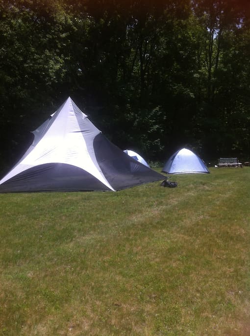 Two 2 person tents, large TIPI in front - TIPI is a separate available booking.