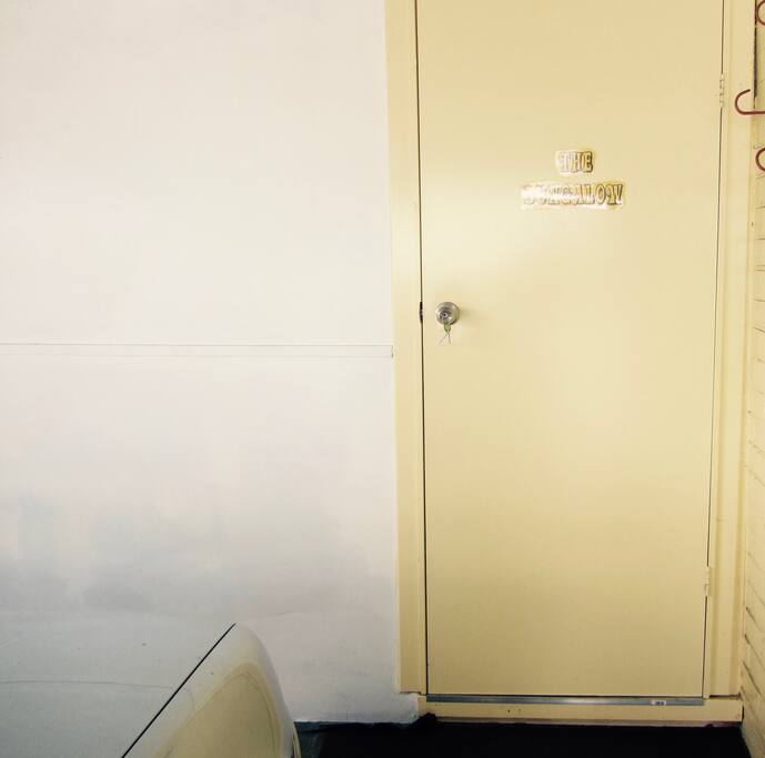 a yellow door. The entrance to The Bungalow