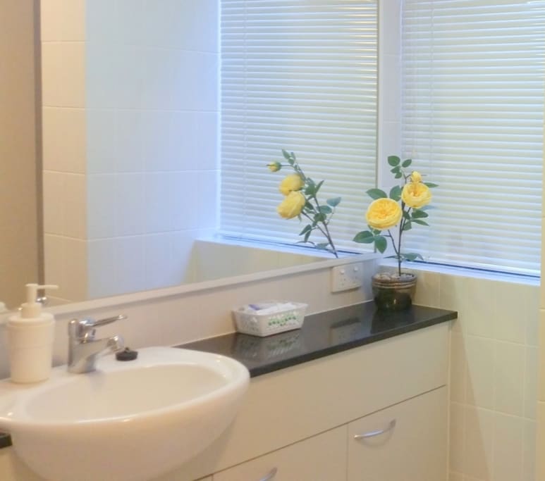 Ensuite with bathtub, bath, pool towels, complimentary soap, shampoo, conditioner