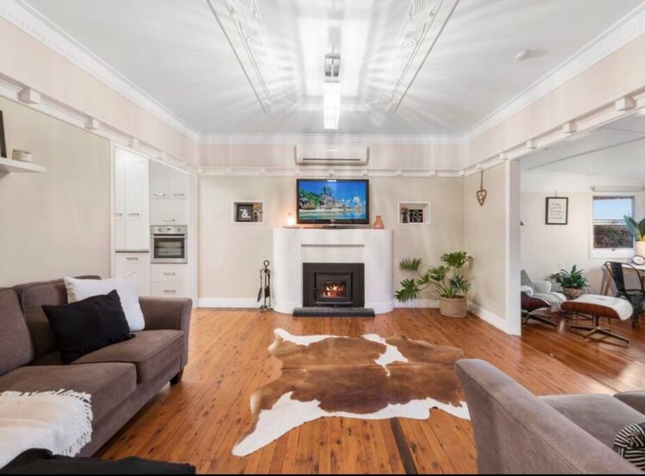 Shared living area with aircon and fireplace