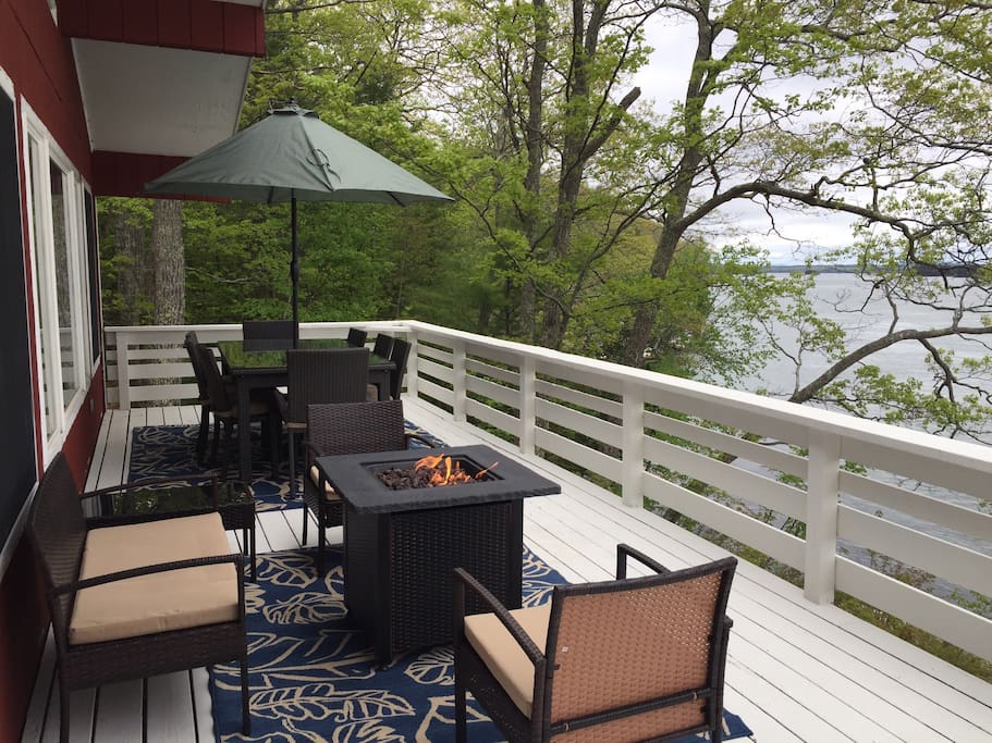 The back deck overlooks the ocean and has a 8 person table plus seating area with propane fire pit and a BBQ grill.