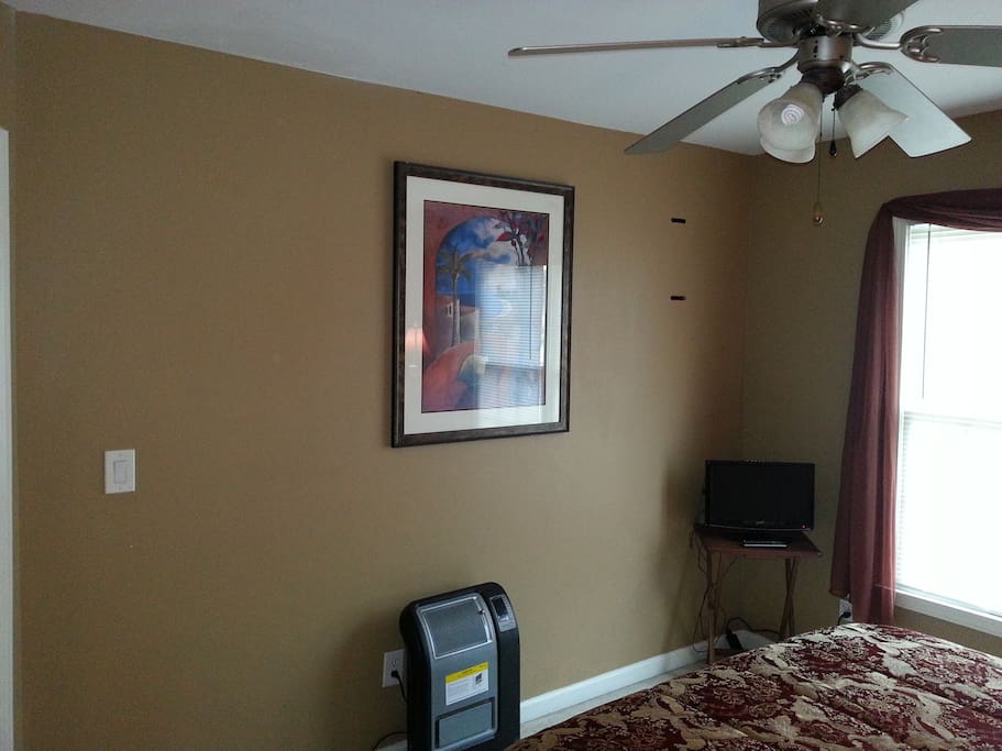 Private bedroom with cozy full sized bed and ammenities such as television. Doors lock from the inside of the room.