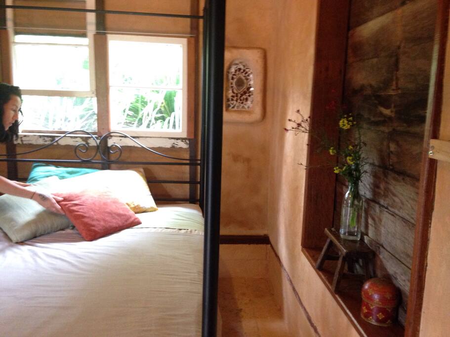 Cosy bedroom with rendered walls and candle alcoves