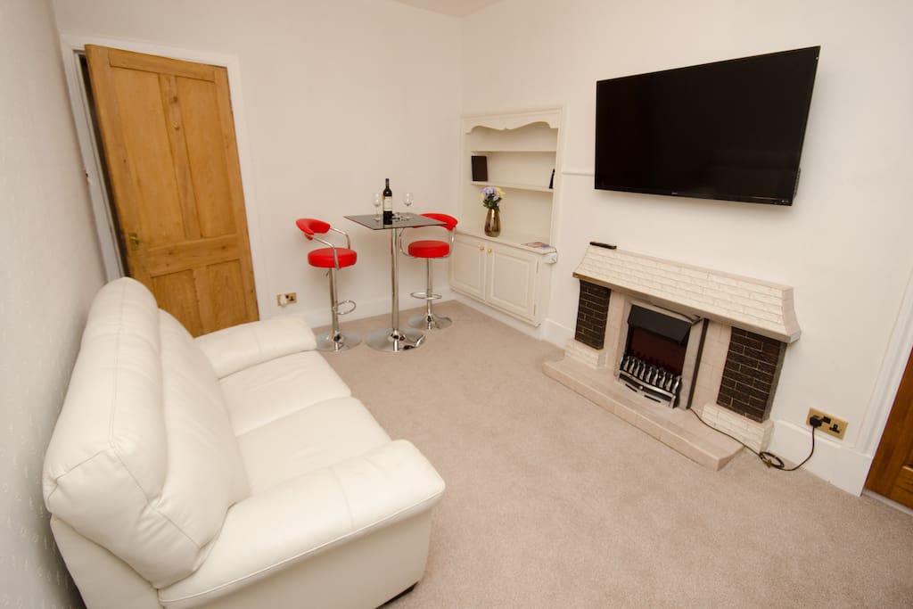 Relax on a comfy couch, there is a 50" wall mounted TV