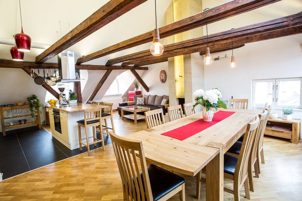 The spacious main loft floor with living room, fire place and our open kitchen island & bar, solid oak dinner table for up to 12 ... just a the few steps to the attic.
And for when there's even more guests then what the four bedroom's can accomodate, there is a comfy Italian sleep sofa (expands to 1.70 m by 2.45 m).
