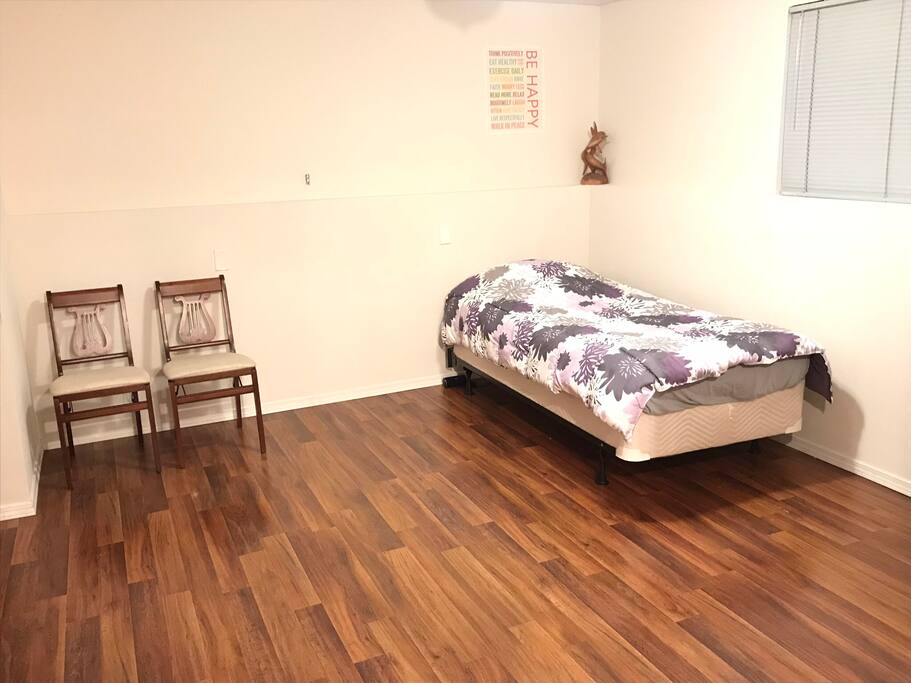 Twin bed located in other half of bedroom