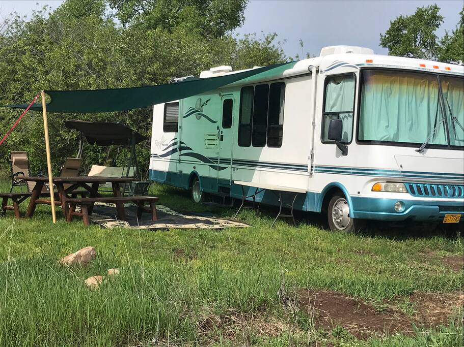Shade Awning, Outdoor Carpet, Swing, Lawn Chairs, Picnic Table and Gas Grill