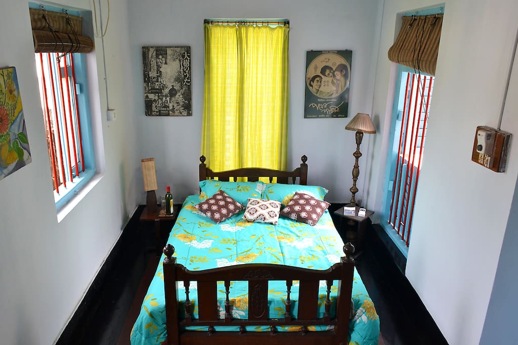 Breezy sunlit bedroom with two large french-windows