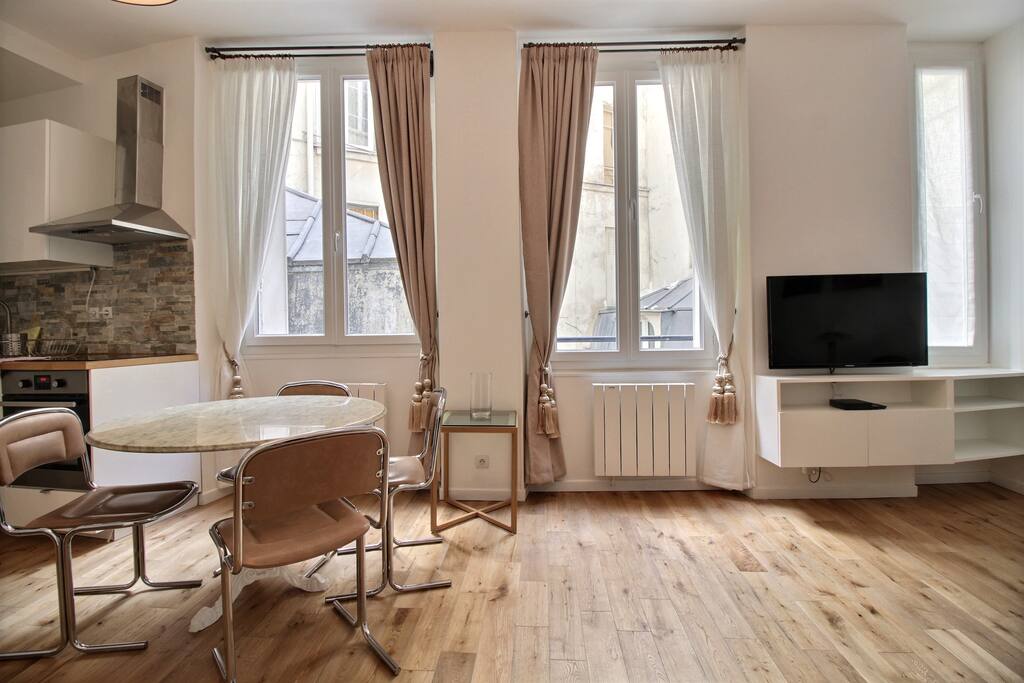 Living room with sofa, TV and dining area