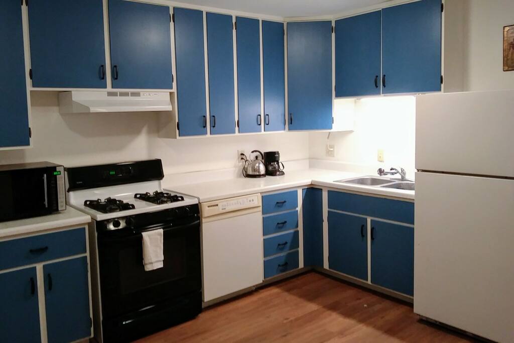 Kitchen with gas stove, non-stick and cast iron cookware, utensils, dishes, coffee & tea
