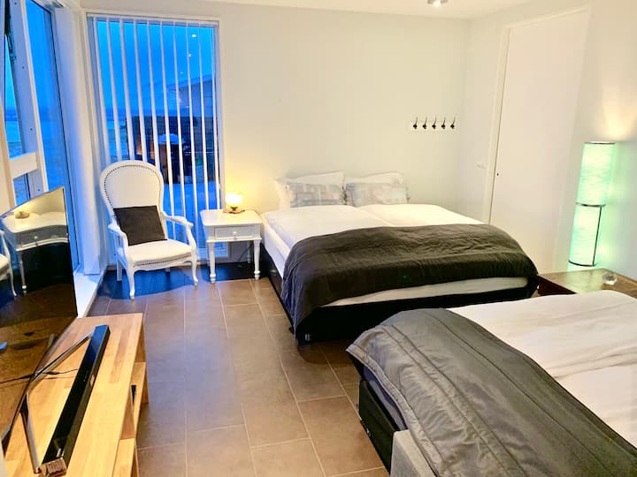 Bedroom 3 - King bed and  a comfortable sofa bed. Blackout curtains, floor to ceiling windows with river and mountain view.
