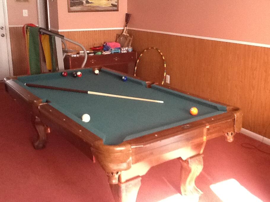 family room with TV, games, 1/2 bath and access to yard