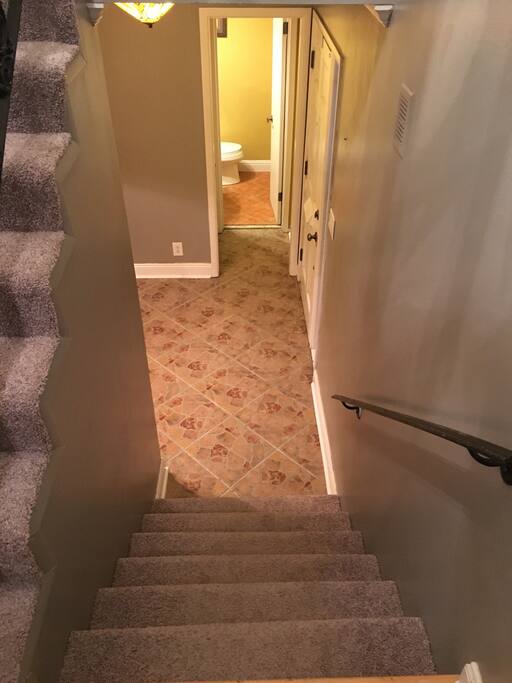 Staircase to front door and half bathroom downstairs.