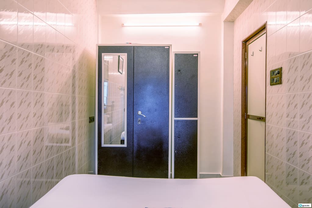 The bedroom is equipped with a 2-door cupboard exclusively for the guests to use, a sturdy wooden frame bed and an air conditioner - in bedroom and living room.