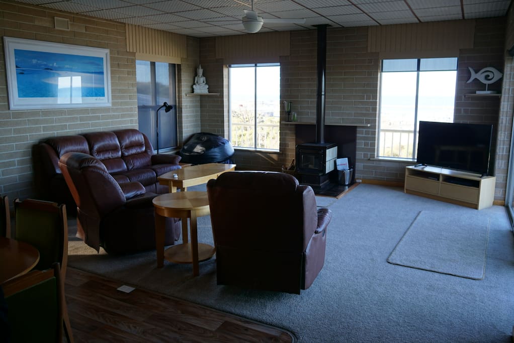 Spacious and light lounge with pot belly fire and incredible views of marina and bay.