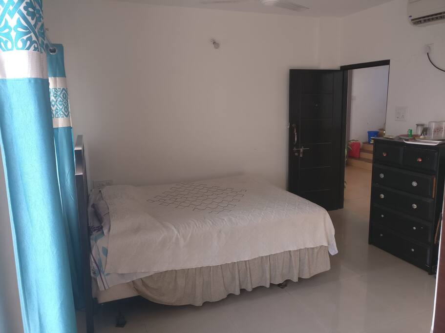 Partial view of the studio with it's private entry door and queen bed