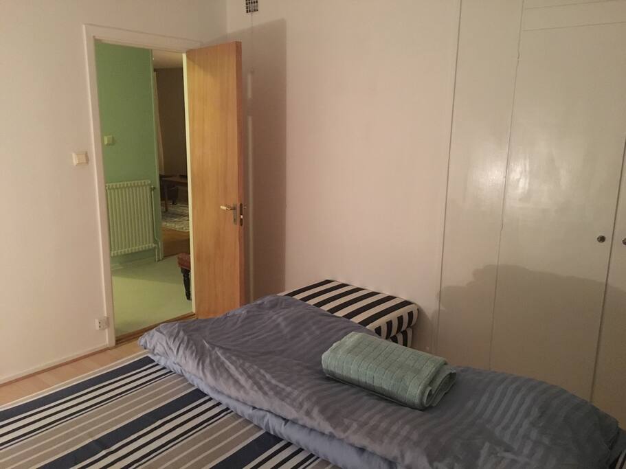 A view of the room from the other side of the room, showing the hallway and the living room.