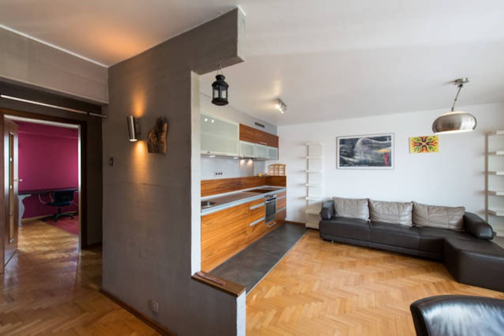 livingroom with dining table, kitchen and sofa bed