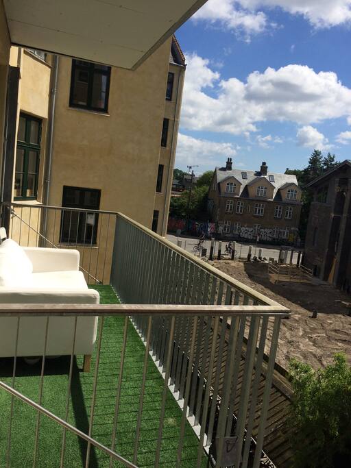 A couch on the balcony pointing south. Great spot to enjoy the morning tea or coffee.