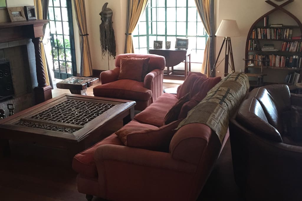 The cozy living room with many books to enjoy around the fireplace.