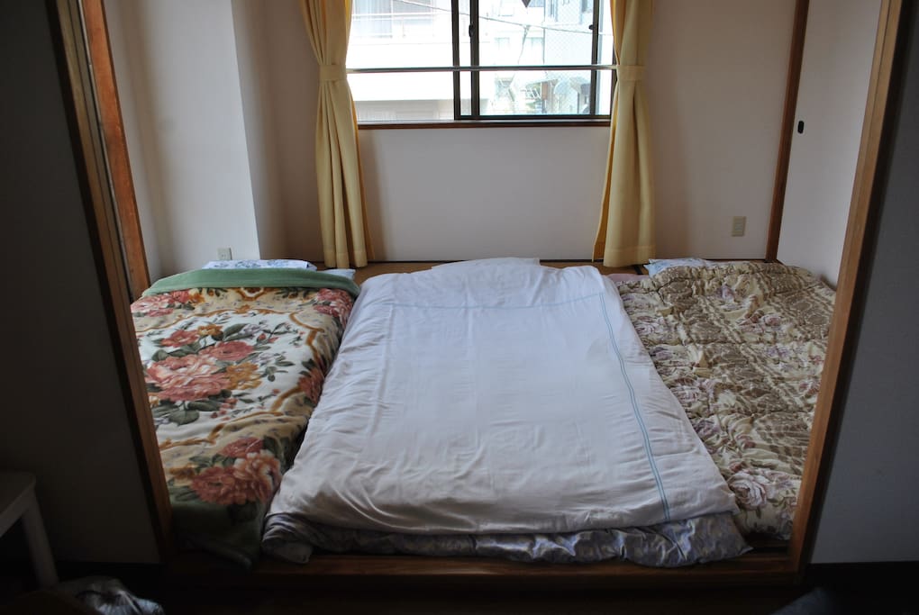 Here are the three futons placed in the Japanese-style room. You can store the black sofas in the closet to the right of the futons, and the table can be places just outside your room.