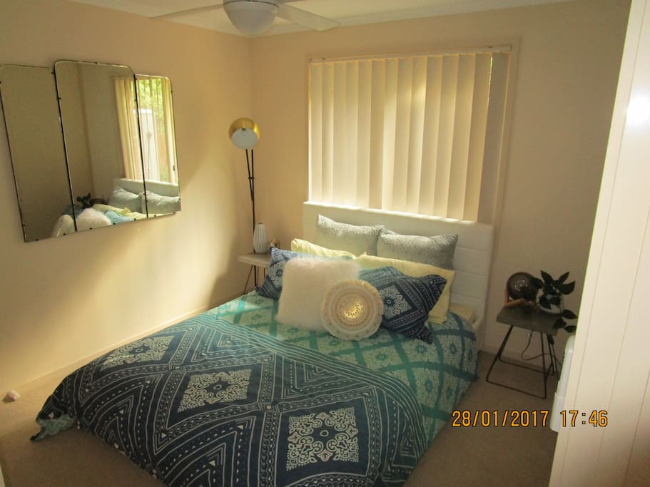 Bedroom with queen size bed and ceiling fan - gets some afternoon sun
