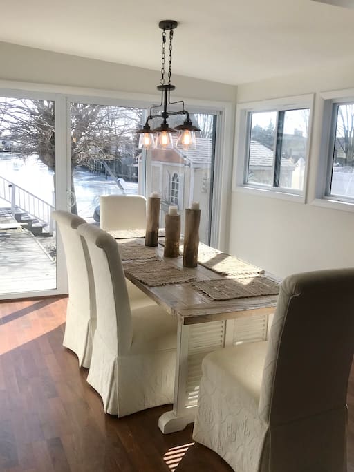 Sunny dining room overlooking expansive deck and the beautiful lagoon!