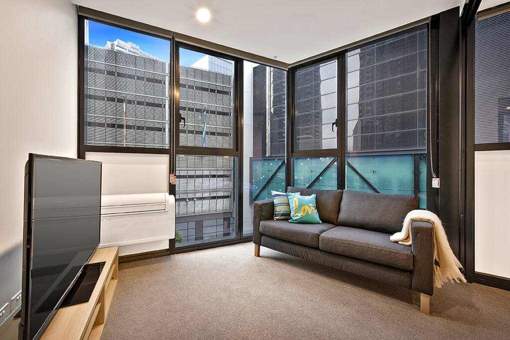 Living area overlooking crown complex with flat screen TV, heating and air-conditioning