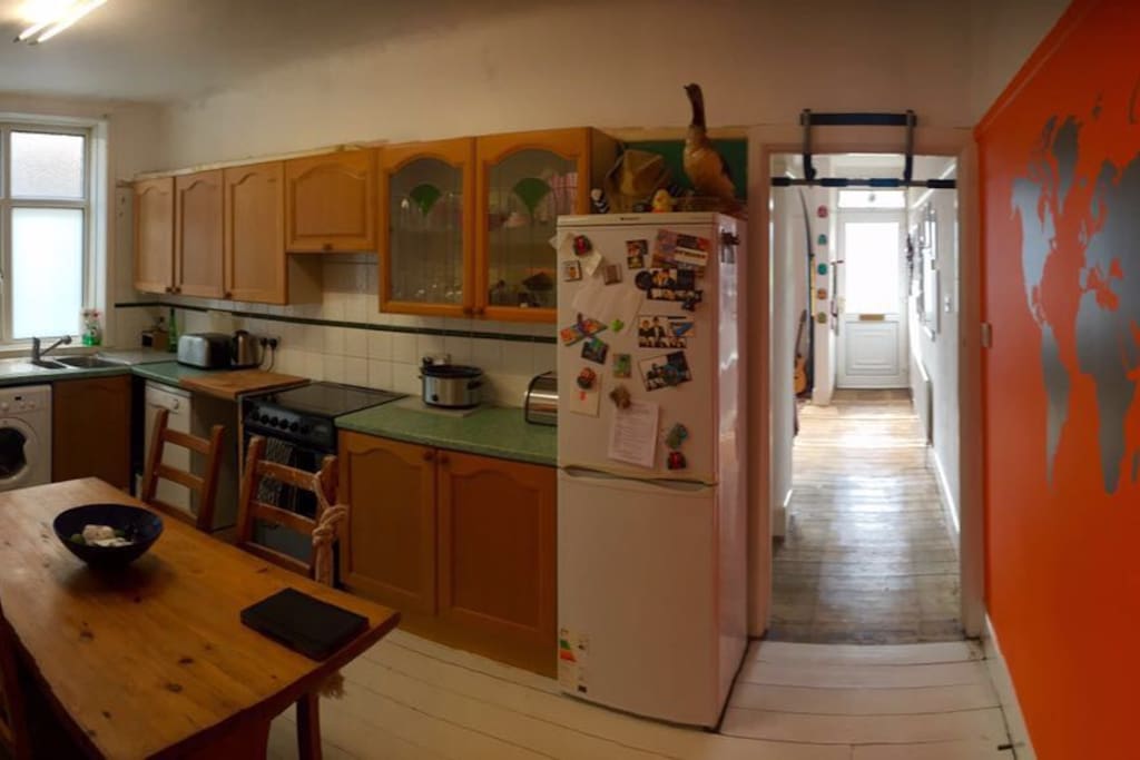 Spacious kitchen with dinner table, fridge, freezer, washing machine, oven and all kitchen amenities at your disposal.